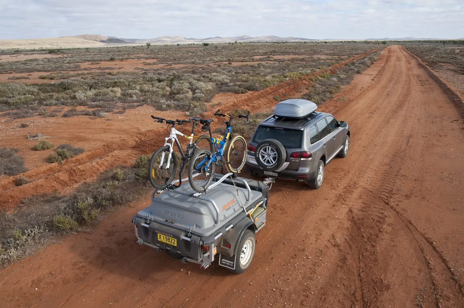 Stockman Pod Trailer towed by a 4WD along a red outback track
